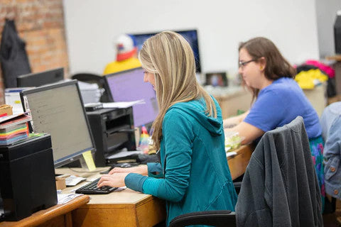two women working at their computers