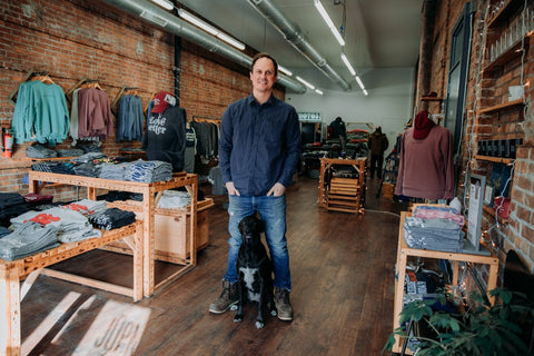 john amato and his dog penny in the jupmode retail store