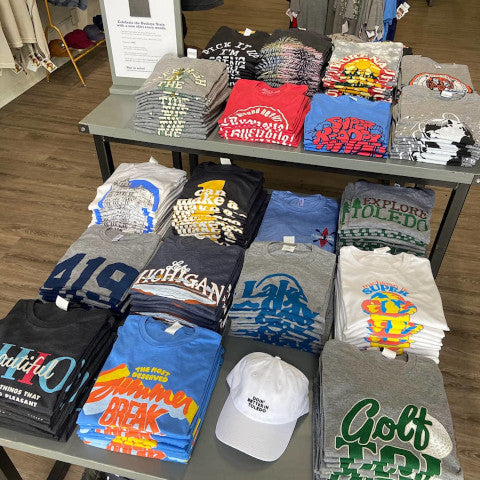 assorted shirts on display at fancysweetstx’s Cricket West retail store