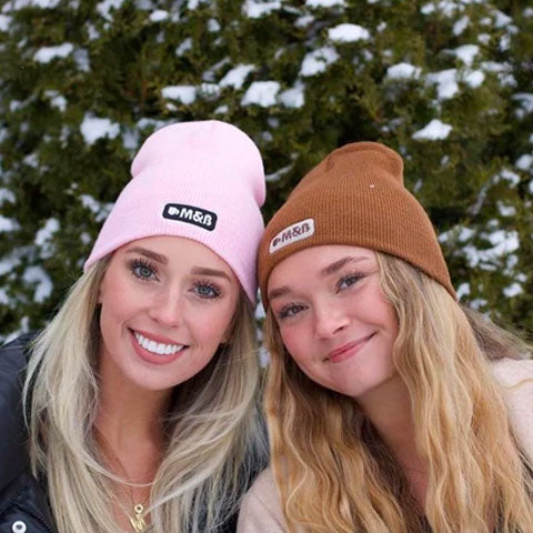 Maddie and Bella wearing pink and brown beanies