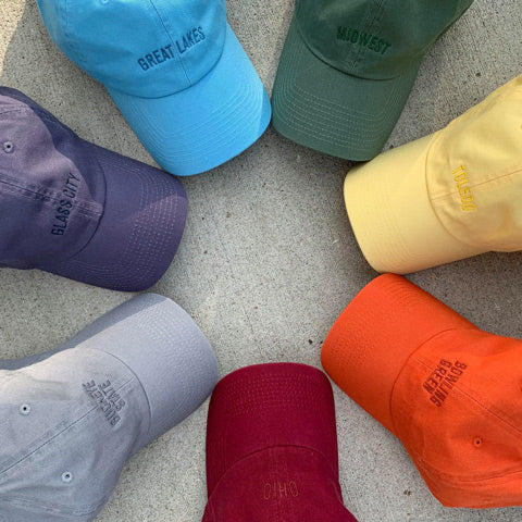 different colored dad hats arranged in a circle