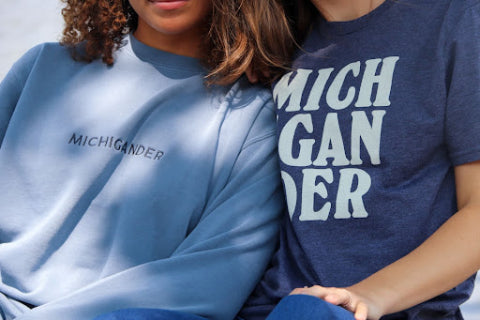two girls wearing embroidered sweatshirt and screen printed t-shirt